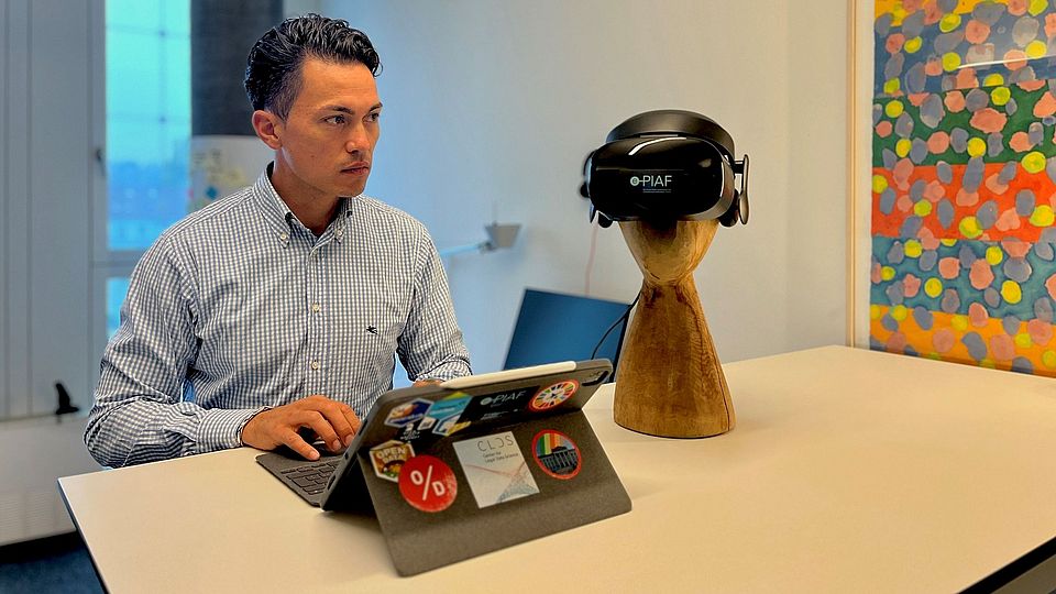 Apollo Dauag at the standing desk, iPad and VR glasses next to him.