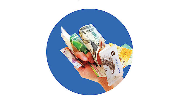 Picture of a hand holding bank notes with a blue background.