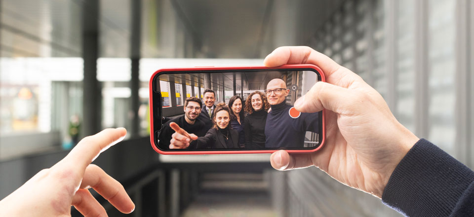 Team members of the e-PIAF research center on a smartphone display as a selfie