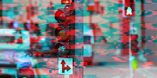 Iconic image for the Opportunities to Use New Data section with a traffic light in the foreground and traffic in the background in a red and blue look.